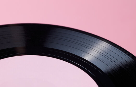 Close-Up of Vinyl Record Grooves on Pink Background