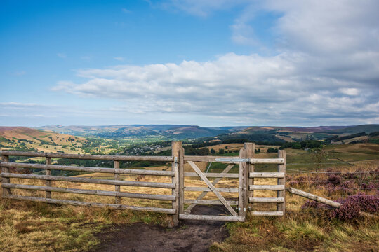 Stunning Peak District landscape from Surprise View with vibrant heather and dappled sunlight over the hills