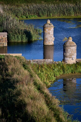 Stone lock towers of Kamienna Sluza reflected in the Motlawa River channel in Gdansk, Poland © sebastiangora