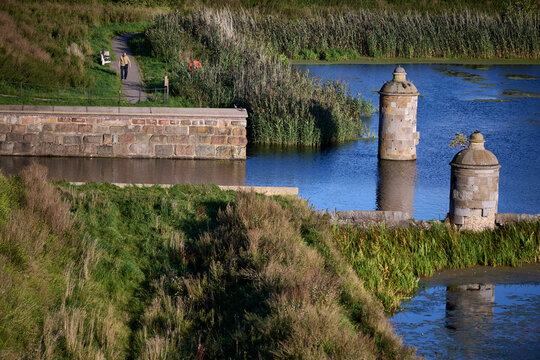 Historic stone lock towers of Kamienna Sluza standing in the water channel in Gdansk, Poland