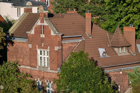 High angle view of a historic red brick building roof with gables and chimneys in Gdansk, Poland