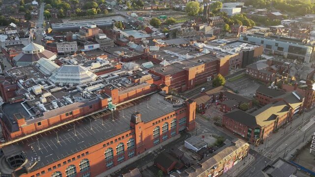 Aerial video of Oldham Civic Centre and Town Centre Rooftops at Golden Sunrise