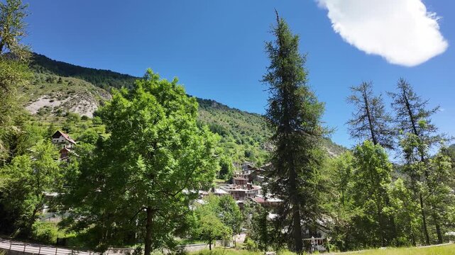 4K footage, a panoramic view of a mountain village and its valley in the Alpine Piedmont region of Upega&mdash;near Ormea&mdash;during the summer months. Ideal for travel guides and mountain vacations.