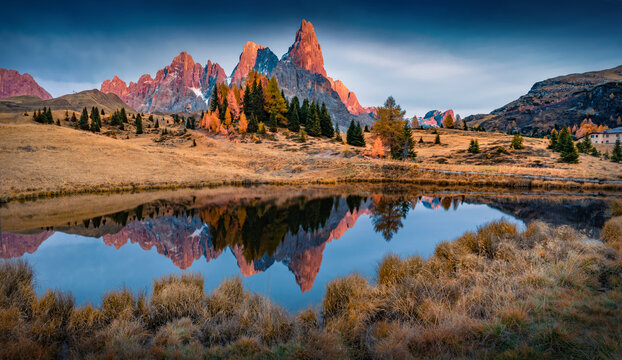 Dramatic autumn sunset on Cimon della Pala peak. Wonderful evening scene of Dolomite Alps with small mountain lake. Colorful outdoor scene of Italy, Europe. Beauty of nature concept background.