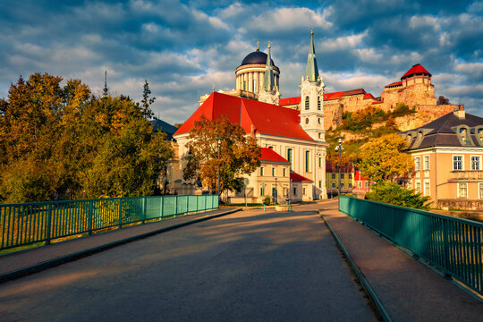 Bright evening view of St Ignatius Church and Basilica of Esztergom on background. Perfect autumn cityscape of Esztergom town, Komarom-Esztergom County, Hungary, Europe. Traveling concept background.