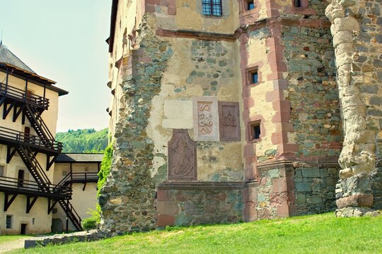 Detailed close-ups of the historic Star&yacute; Z&aacute;mok (Old Castle) in Bansk&aacute; &Scaron;tiavnica, Slovakia, featuring ancient stone reliefs, a round tower, and external wooden galleries.