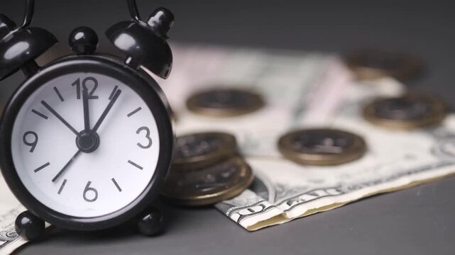 Alarm clock and money on table time is money concept close up shot