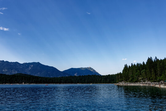 Turquoise Waters and Islands of Lake Eibsee Beneath Zugspitze Mountain Peak