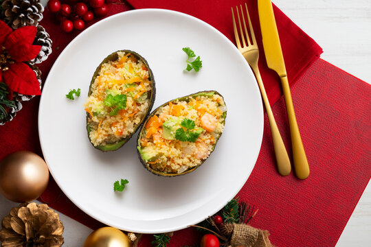 Avocados stuffed with couscous and vegetables. Overhead view of the table. Recipe for celebrating Christmas.