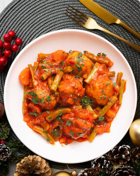 Meatballs with tomato and vegetable sauce. Overhead view of the table. Recipe for celebrating Christmas.