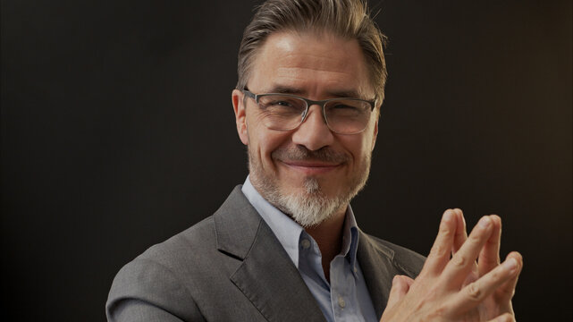 Confident businessman smiling. Portrait of mature age, middle age, mid adult man in 50s, happy confident smile. Copyspace.