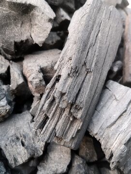 Detailed macro texture of a cracked black charcoal piece