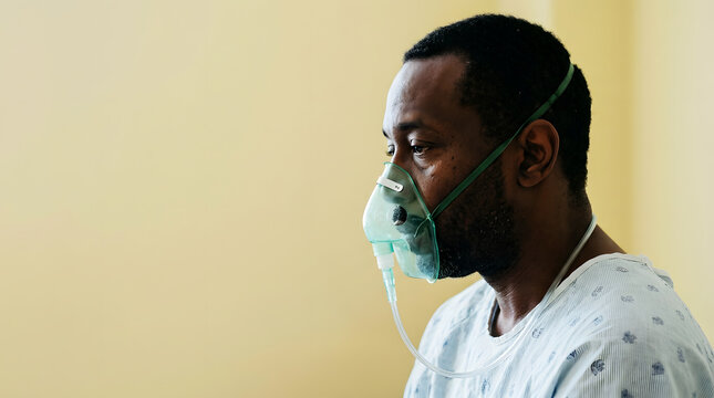 Man thoughtfully looking away while applying shaving cream to beard