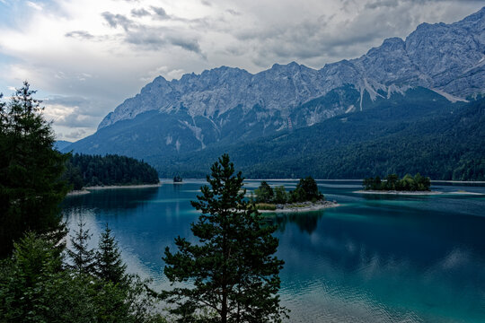 Turquoise Waters and Islands of Lake Eibsee Beneath Zugspitze Mountain Peak