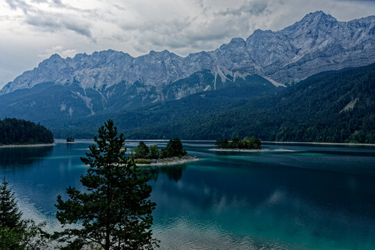 Turquoise Waters and Islands of Lake Eibsee Beneath Zugspitze Mountain Peak