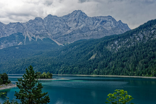 Turquoise Waters and Islands of Lake Eibsee Beneath Zugspitze Mountain Peak