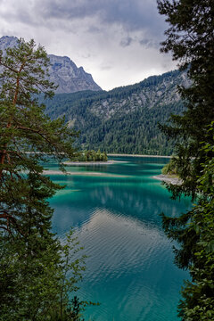 Turquoise Waters and Islands of Lake Eibsee Beneath Zugspitze Mountain Peak