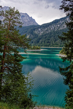 Turquoise Waters and Islands of Lake Eibsee Beneath Zugspitze Mountain Peak