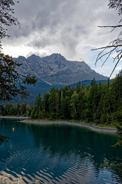Turquoise Waters and Islands of Lake Eibsee Beneath Zugspitze Mountain Peak