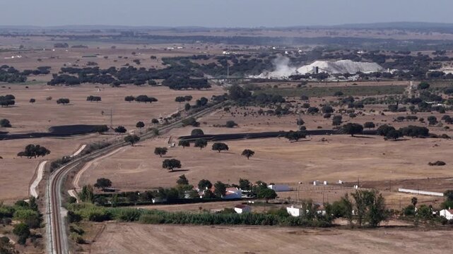 Aerial view of mining operation near railway in Evora, Portugal.