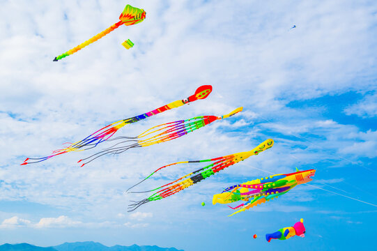 Flying colorful kites in blue sky. Kite Festival in summer