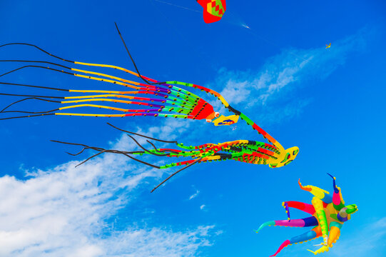 Flying colorful kites in the blue sky. Kite Festival