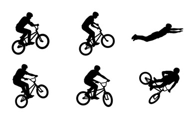 Fototapeta premium BMX cyclists performing stunts and a superman dive silhouette