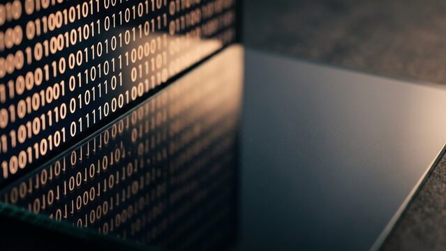 Digital data stream reflected on a laptop screen close up shot of binary code technology concept
