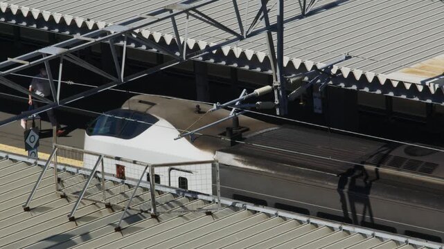 JR driver walking along platform and entering train cab seen from high angle, Hakodate, Japan, 2026.09.10.