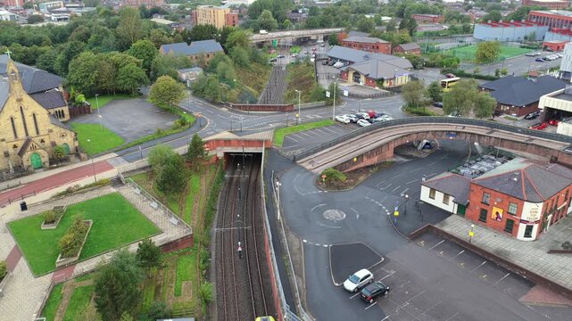Aerial video featuring the King Street Tram Stop in Oldham, Greater Manchester with Metrolink Tram Passing in the morning. 