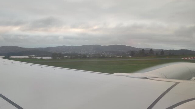 Plane taking off at Bergen Flesland Airport runway airplane takeoff wing window view 4k footage