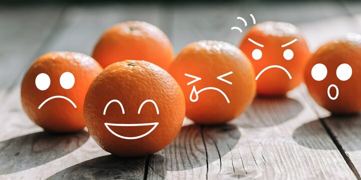 Tangerines with expressive emotion faces, mood variation and emotional awareness concept