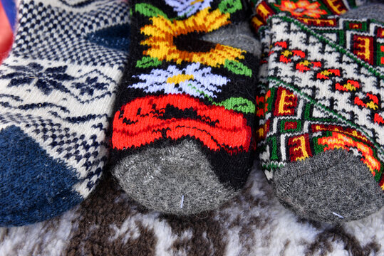 Close-up of colorful traditional handmade woolen socks with floral and geometric patterns