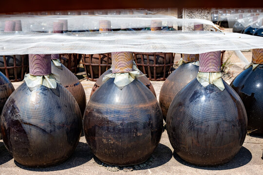 Sunbaked sweet Banyuls fortified wine in traditional demijohns bonbonnes glass jars, Roussillon, French Catalonia, Grenache and Muscat grapes, oxidative sun aging
