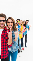 Obraz premium Group of young people with sunglasses making rock gestures and sticking out tongues, symbolizing fun, youth, and rebellion against a white background