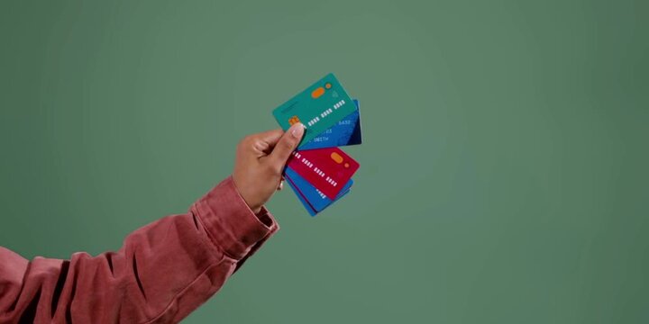 A hand holds many colorful payment cards representing financial transactions and banking services for shoppers needing flexible options for personal spending and secure electronic money