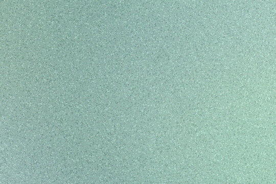 Abstract sea glass surface with soft colorful gradient, blurred coarse grain texture, and granular noise forming a gentle atmospheric background