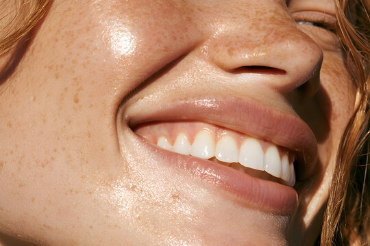 Soft skin with a close-up smile, macro shot, natural freckles, healthy looking face, bright and glowing complexion