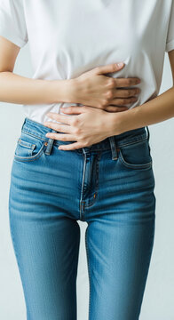 Person holding abdomen in discomfort, suggesting pain or illness. Symbolizes discomfort, sickness, or internal issue, relevant for healthcare or wellness.