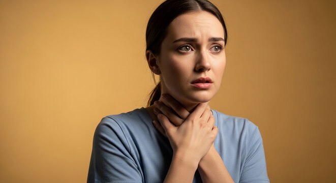 Woman with worried expression clutching her throat, conveying fear or pain, symbolizing anxiety, distress, or medical concern
