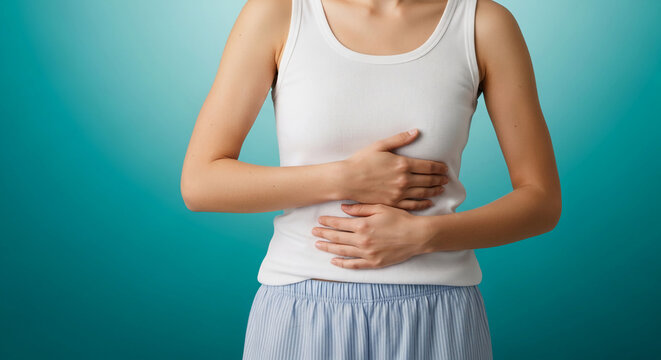 Woman holding painful belly with hands, stomach ache and digestion problems concept