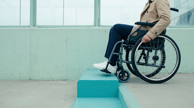 Wheelchair User Facing a Step Barrier, Frustrating Accessibility Obstacle in Modern Public Building