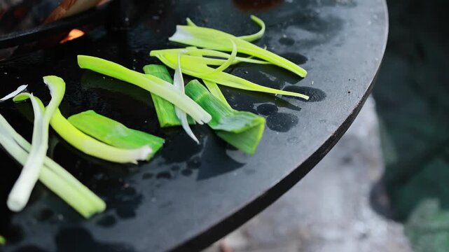 Fresh Leek Slices on a Griddle Over an Open Flame