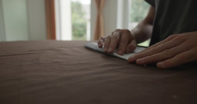 Close-up male hands fold sheet of paper making paper airplane. 4K 10-bit