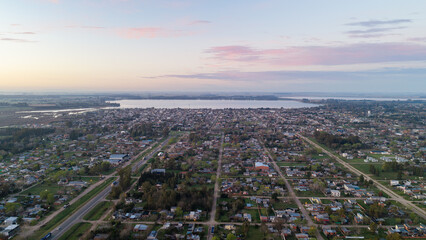 Obraz premium Pastel dawn sky over San Miguel del Monte and Laguna de Monte, Argentina.
