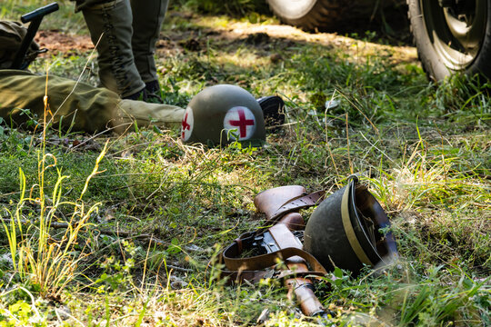 Hel, Poland. August 21, 2026. A historical reenactment from World War II. U.S. helmets and rifle lying on the grass 