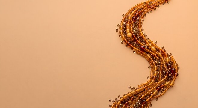 Minimalist Warm Beige Background with S-Curved Strand of Sparkling Gold Beads