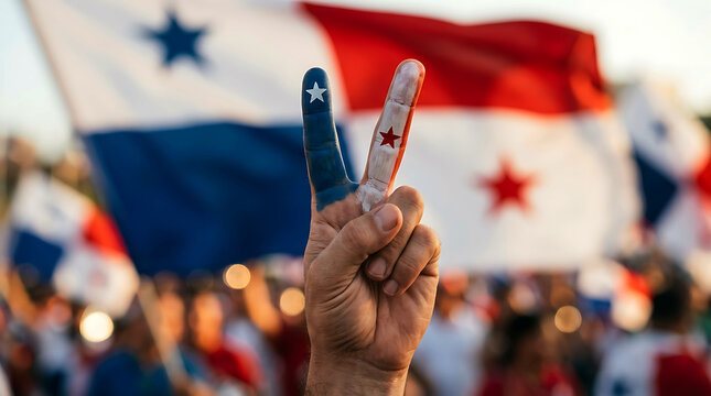Patriotic hand showing peace sign painted like the flag of Panama in a crowd