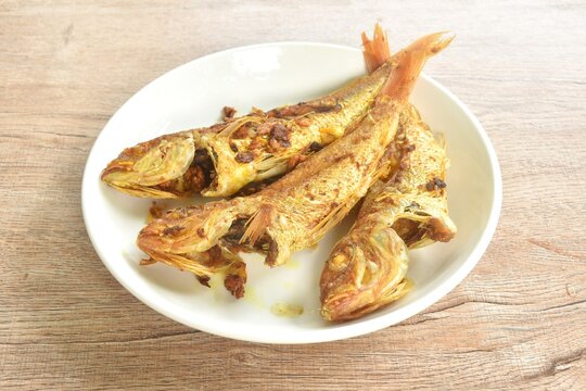 deep fried whisker sheatfish or bleeker sheatfish with turmeric sauce on plate