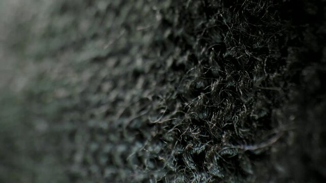 Macro close-up of dark black woven fabric texture